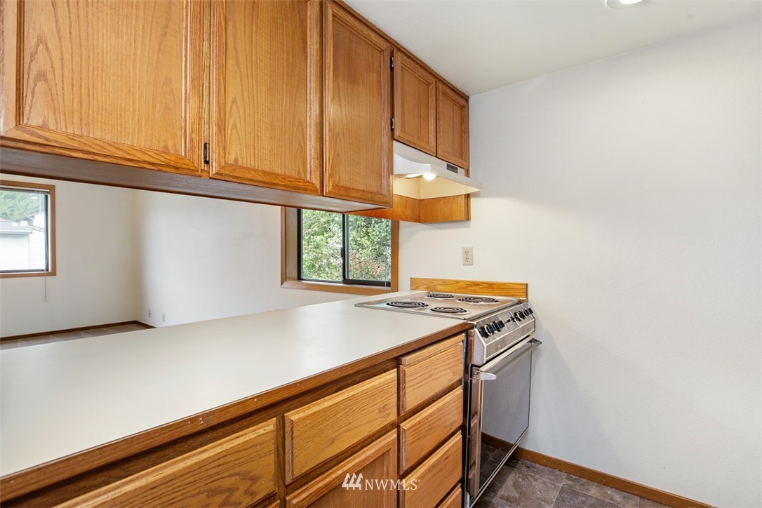 1300 North 107th Street Seattle, WA 98133 - Photo 14 of 20 a kitchen with a sink cabinets and a window