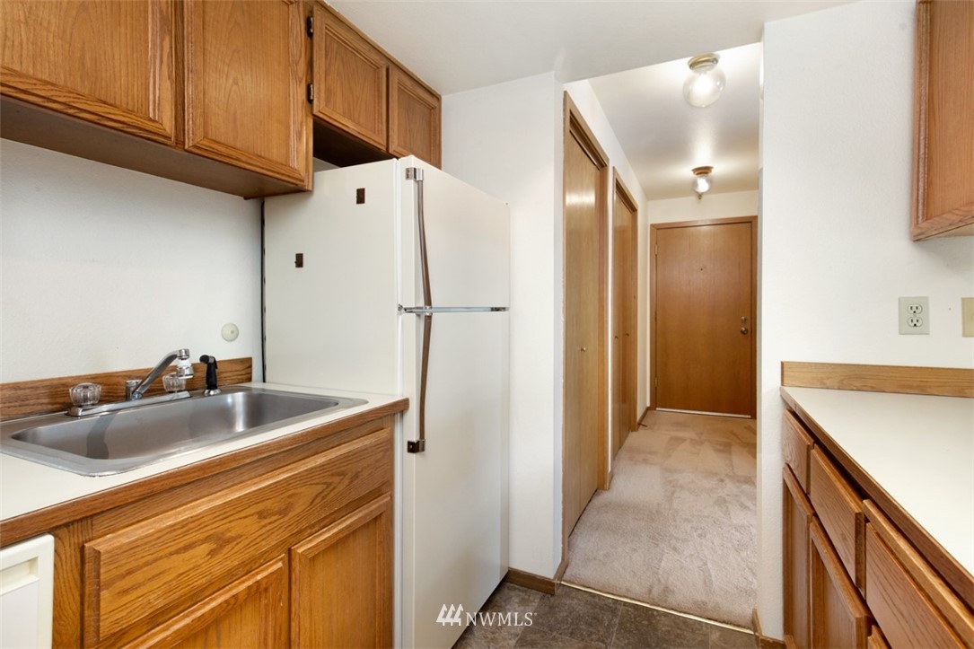 1300 North 107th Street Seattle, WA 98133 - Photo 15 of 20 a kitchen with a sink and a refrigerator