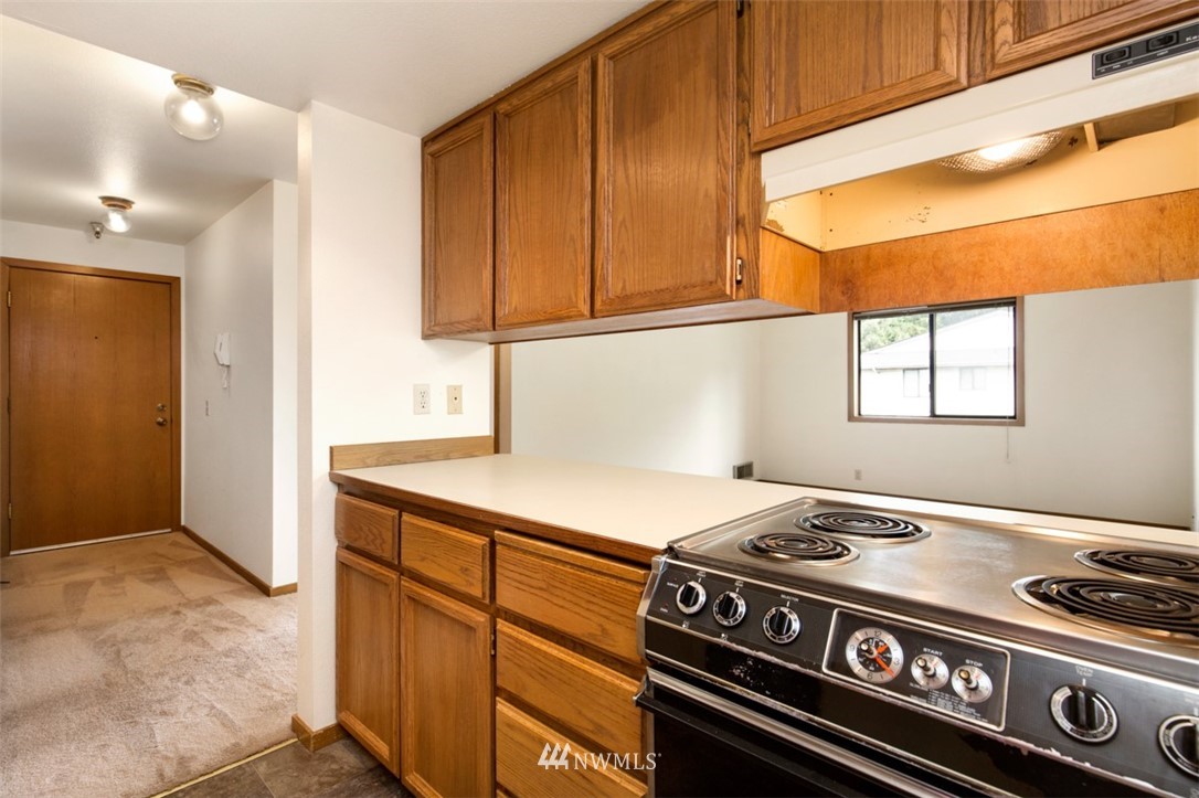 1300 North 107th Street Seattle, WA 98133 - Photo 16 of 20 a kitchen with a stove and a microwave