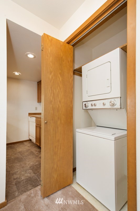 1300 North 107th Street Seattle, WA 98133 - Photo 17 of 20 a view of washer and dryer with kitchen in the background