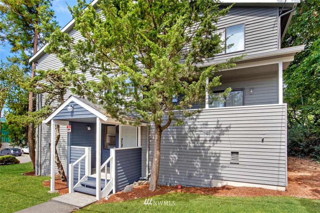 1300 North 107th Street Seattle, WA 98133 - Photo 3 of 20 a front view of a house with garden