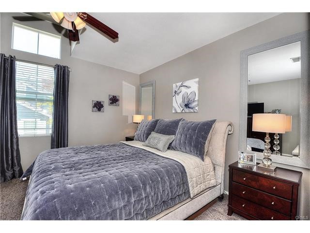 55 Ellsworth Street, Unit 27 Ladera Ranch, CA 92694 - Photo 20 of 34 a bedroom with a bed and a lamp