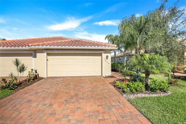 a view of a house with a yard and a garden