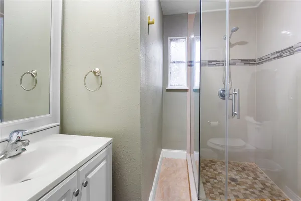 a bathroom with a sink and shower