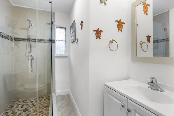 a bathroom with a shower and a sink