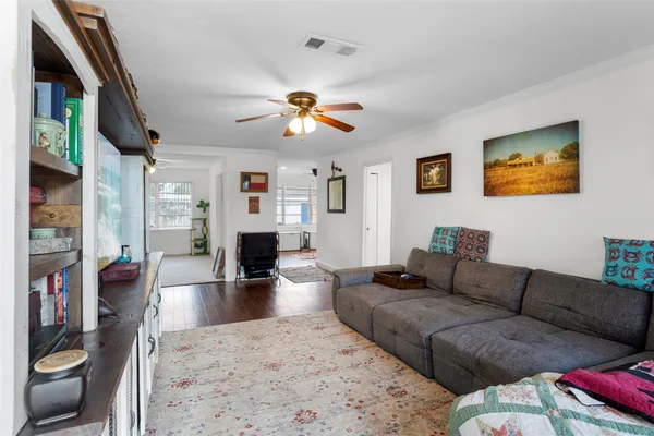 a living room with furniture ceiling fan and a rug