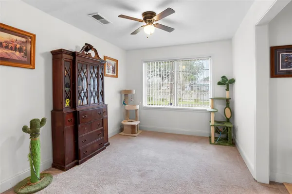 a view of a room with window and a ceiling fan