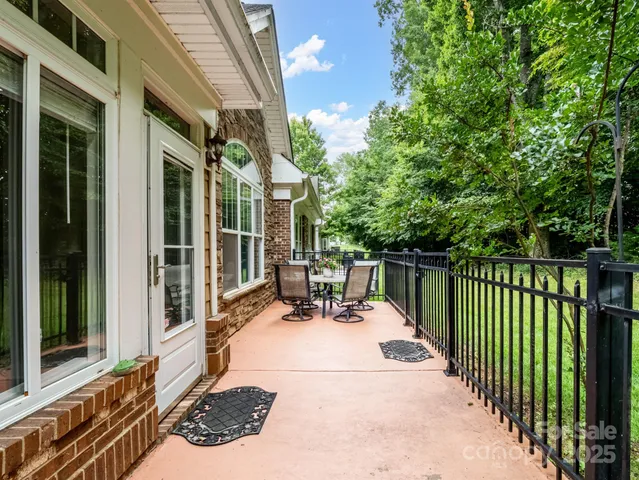 a view of a house with a yard and sitting area