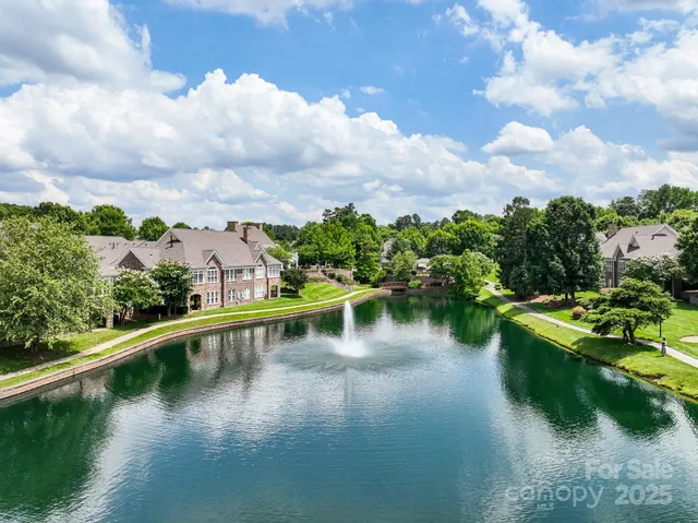 an aerial view of a house with a garden and trees