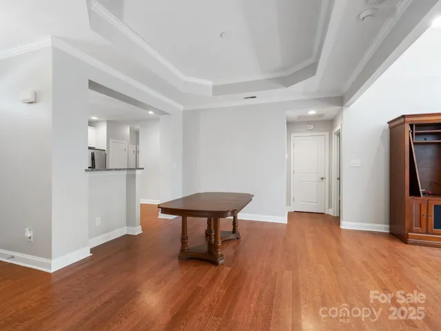 a living room with stainless steel appliances kitchen island a table and chairs