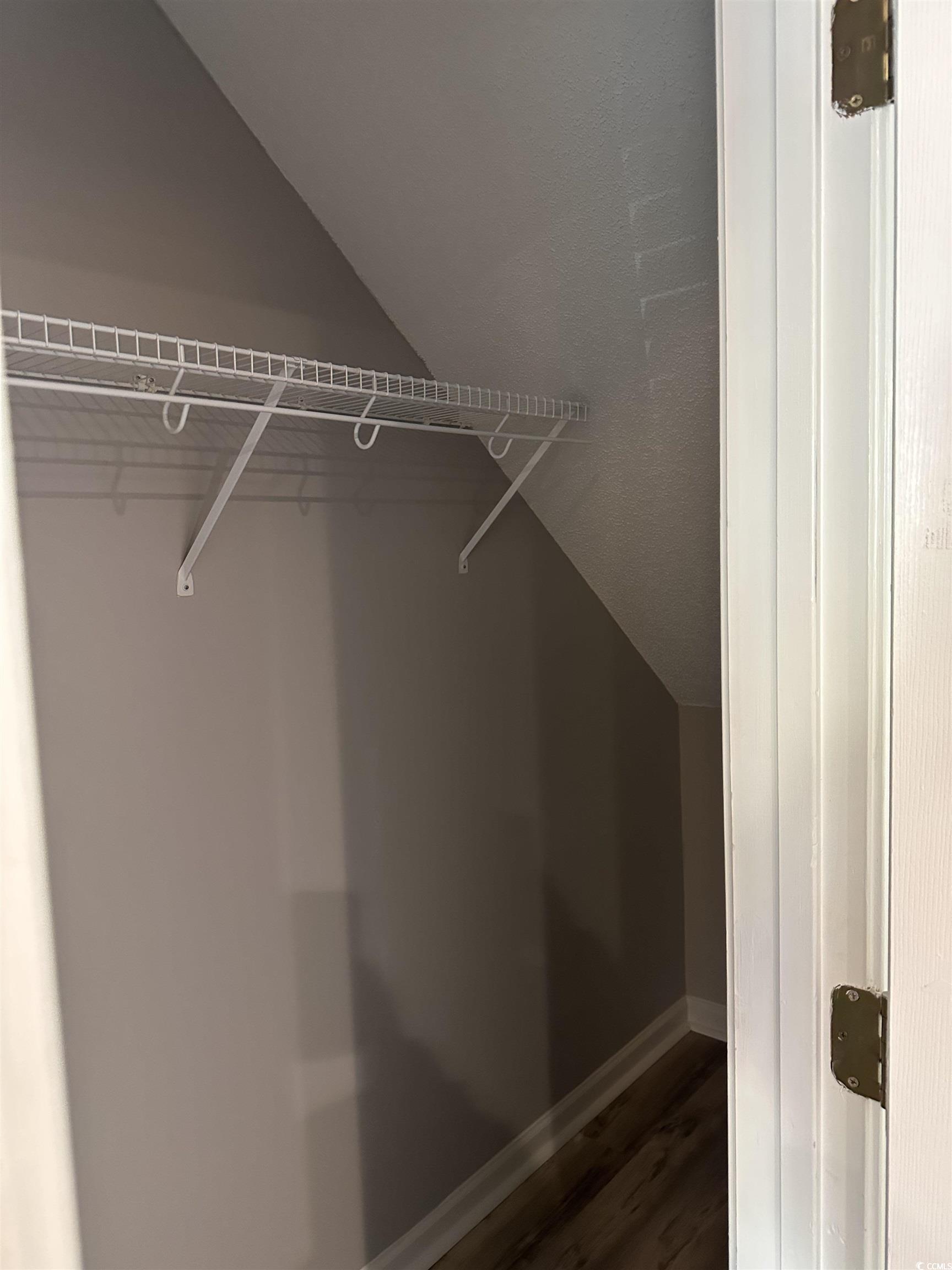 257 Seabert Road Myrtle Beach, SC 29579 - Photo 16 of 16 Walk in closet featuring vaulted ceiling and wood finished floors