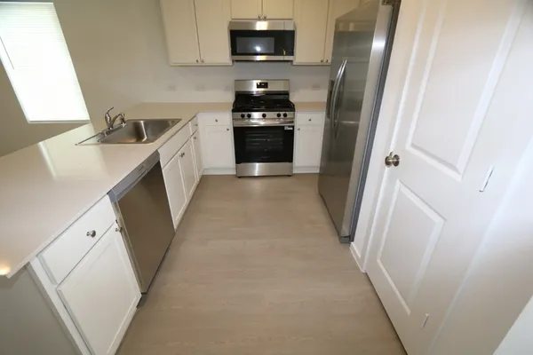 a kitchen with a sink and a refrigerator