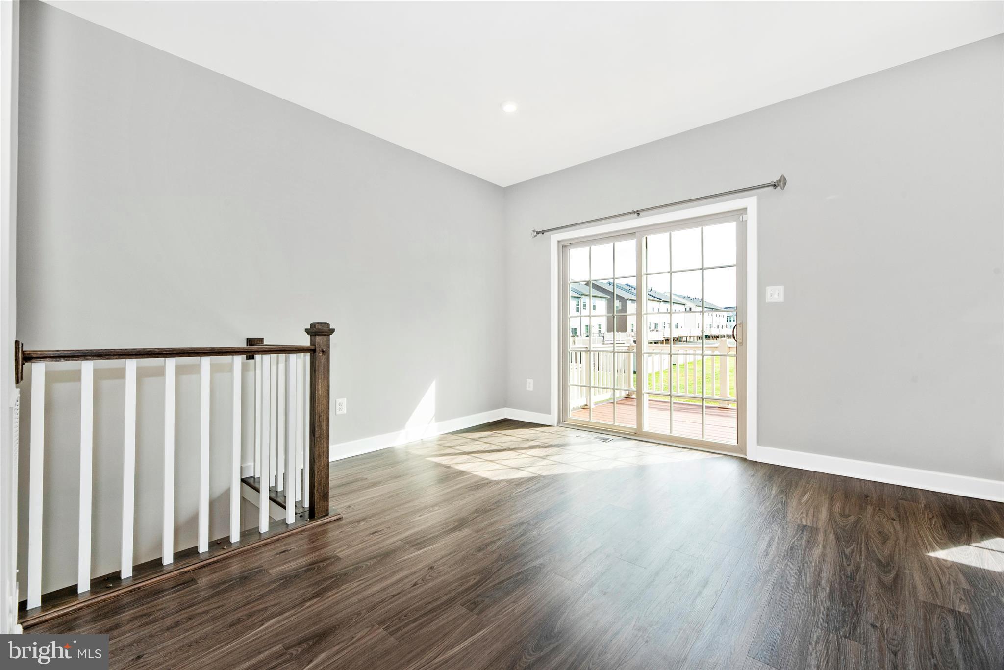 7091 Kokanee Way New Market, MD 21774 - Photo 13 of 69 an empty room with wooden floor and windows