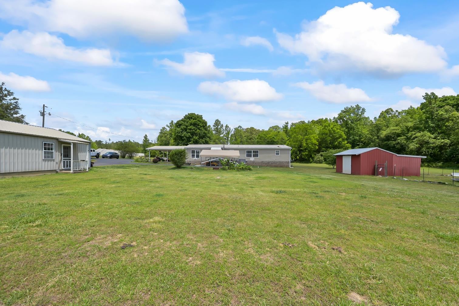 6439 Cedar Grove Road Big Sandy, TN 38221 - Photo 30 of 38 a backyard of a house with lots of green space