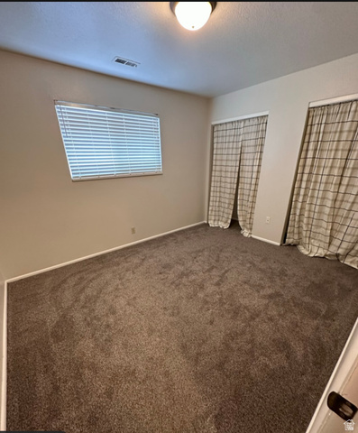 102 East Richelman Lane Wellington, UT 84542 - Photo 13 of 14 Neutral wall paint, window with horizontal blinds, flush mount ceiling light, and carpeted flooring