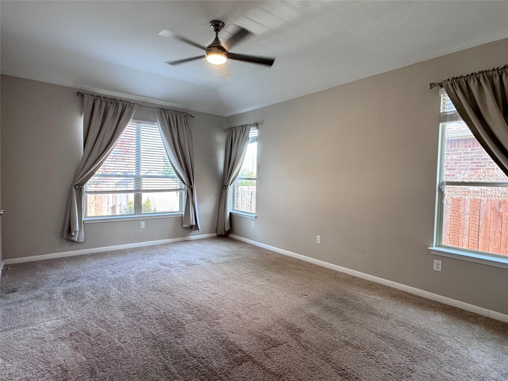 16420 Pienza Drive Pflugerville, TX 78660 - Photo 13 of 26 Carpeted spare room with ceiling fan and baseboards