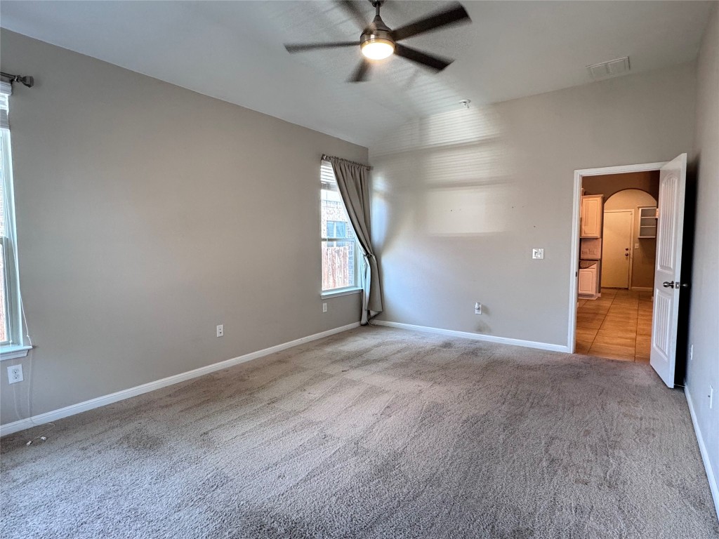 16420 Pienza Drive Pflugerville, TX 78660 - Photo 14 of 26 Unfurnished bedroom with arched walkways, a ceiling fan, carpet, and lofted ceiling