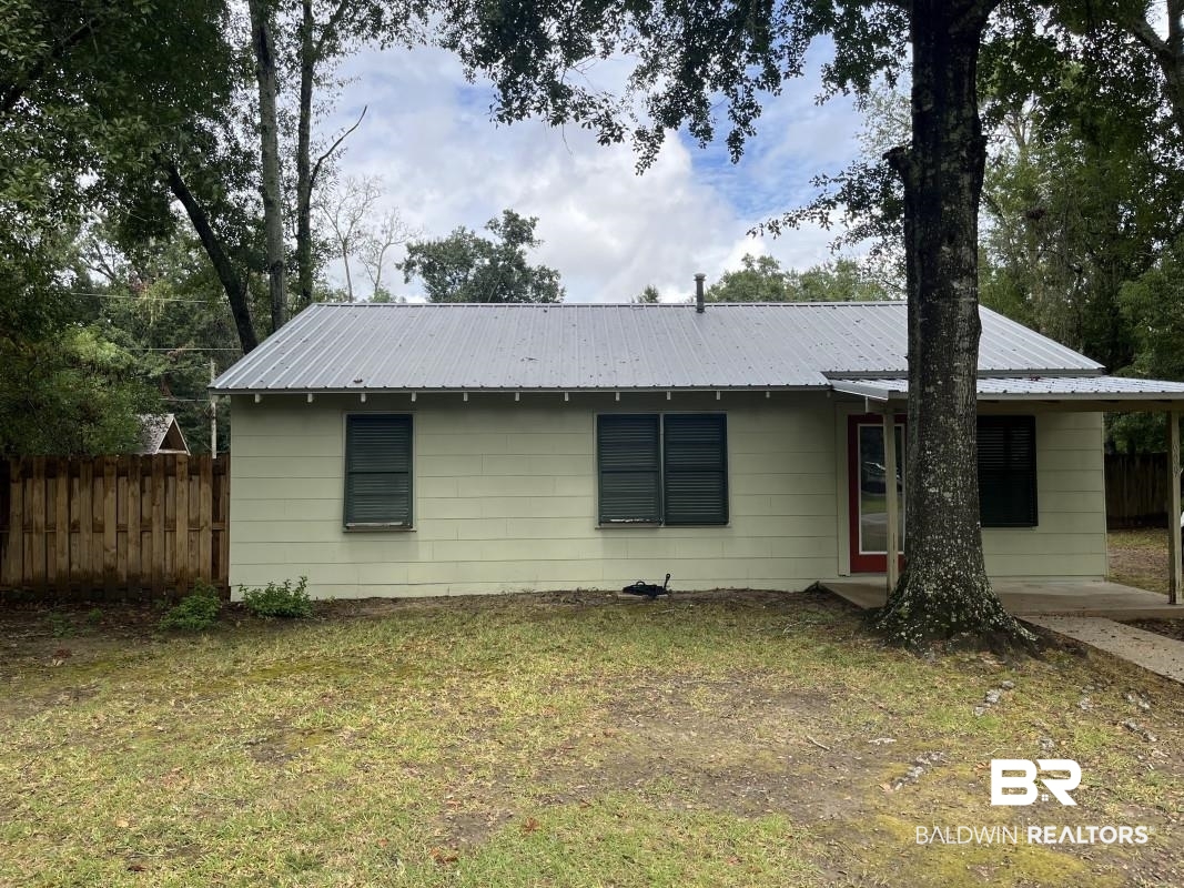 609 East Orange Avenue Foley, AL 36535 - Photo 1 of 6 Rear view of house featuring a metal roof