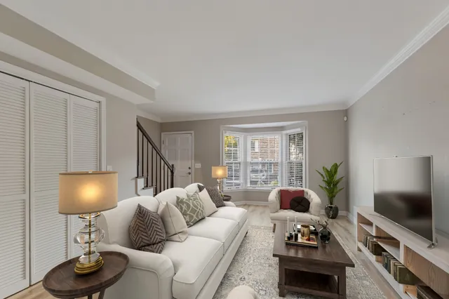 a living room with furniture a flat screen tv and a large window
