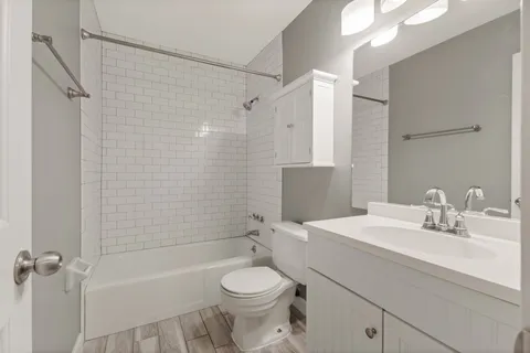 a bathroom with a sink toilet and shower