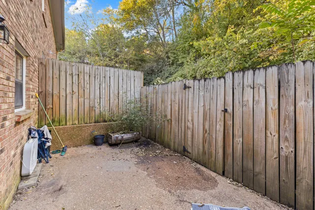a backyard of a house with chairs