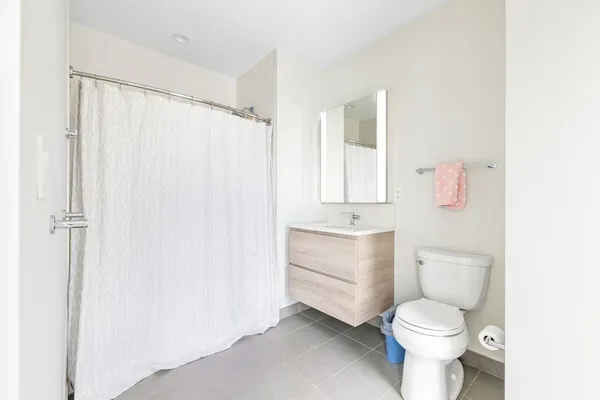 a white toilet sitting next to a bathroom sink