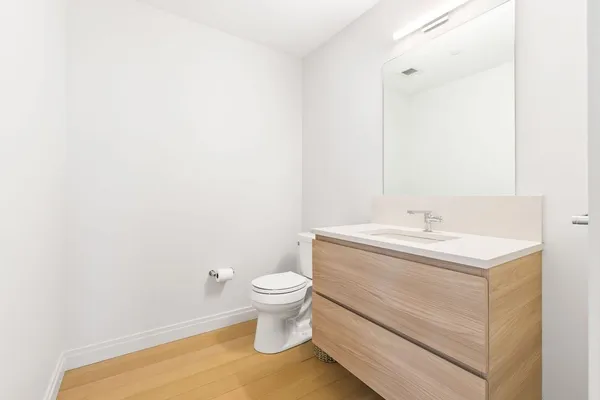 a bathroom with a sink toilet and vanity