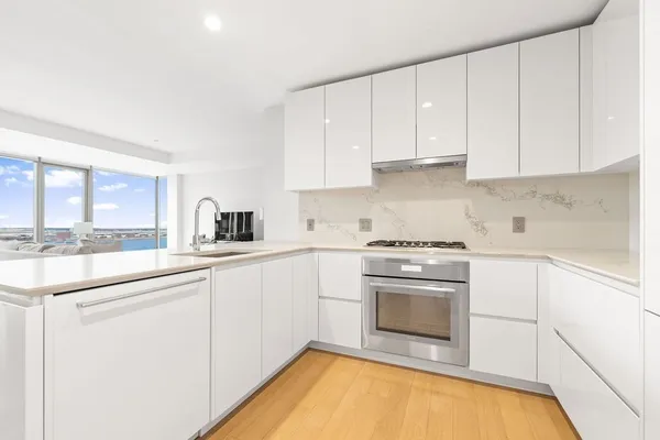 a kitchen with a sink stove and cabinets