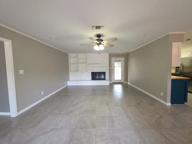 wooden floor in an empty room with a fireplace