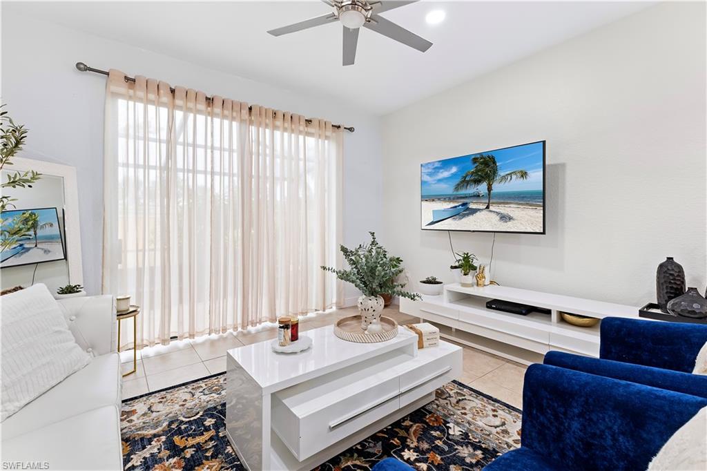 7542 Bristol Circle Naples, FL 34120 - Photo 10 of 26 Tiled living room with ceiling fan