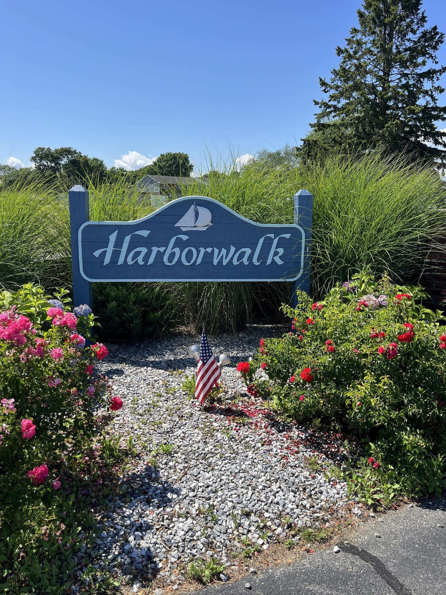 25 Riverside Drive, Unit B9 Clinton, CT 06413 - Photo 1 of 1 a sign that is sitting in front of flowers
