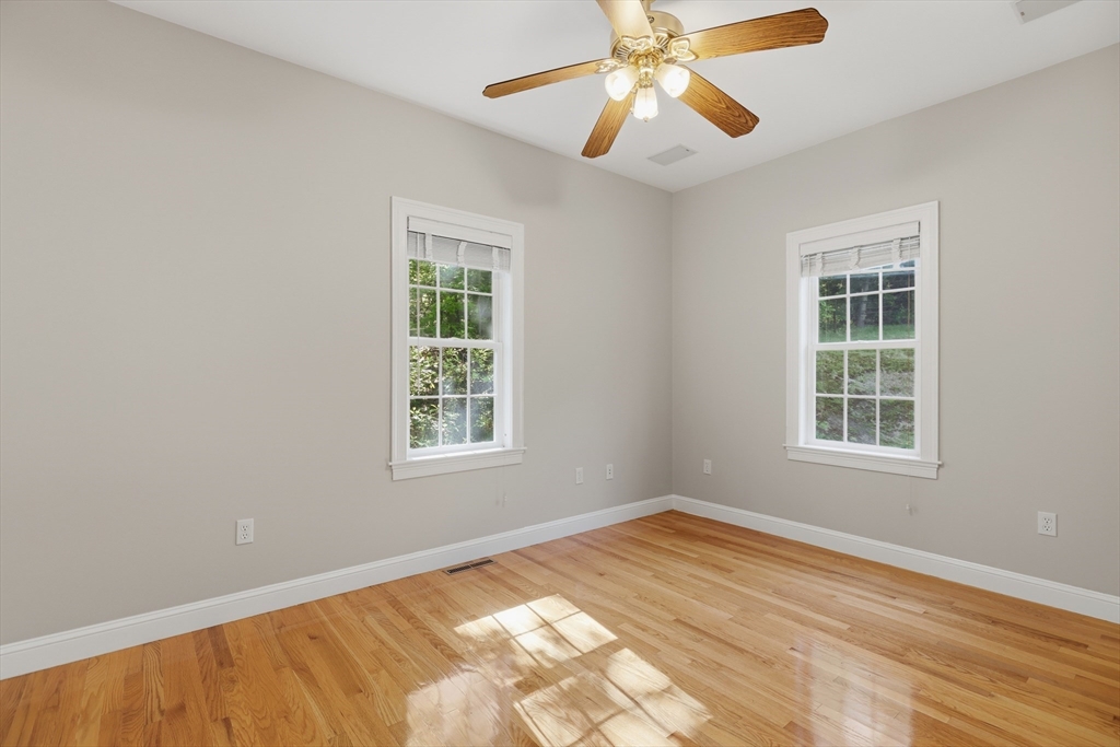61 Indian Head Road Framingham, MA 01701 - Photo 17 of 42 a view of an empty room with wooden floor and a window