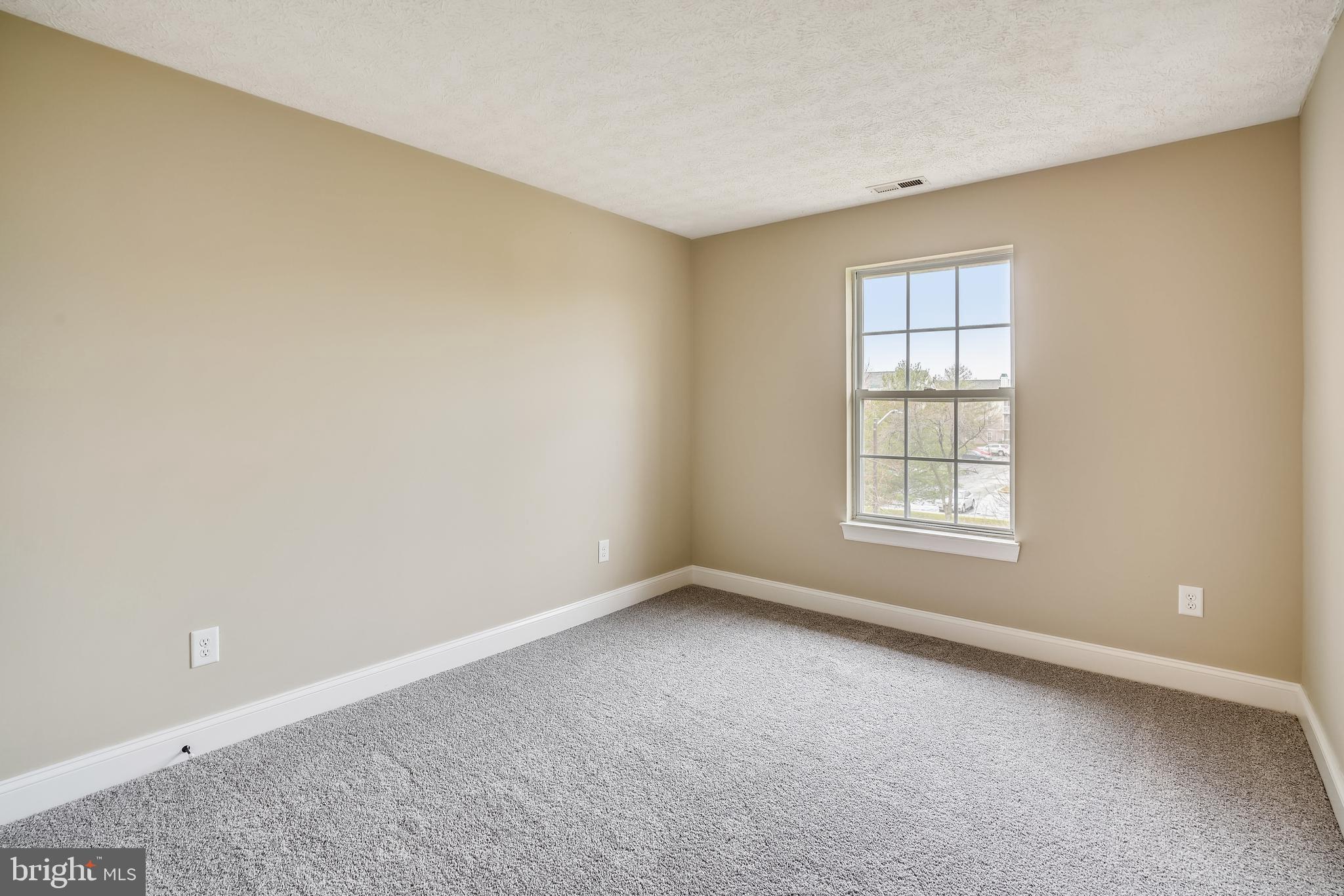 2408 Forest Edge Court, Unit 303 Odenton, MD 21113 - Photo 13 of 46 an empty room with windows