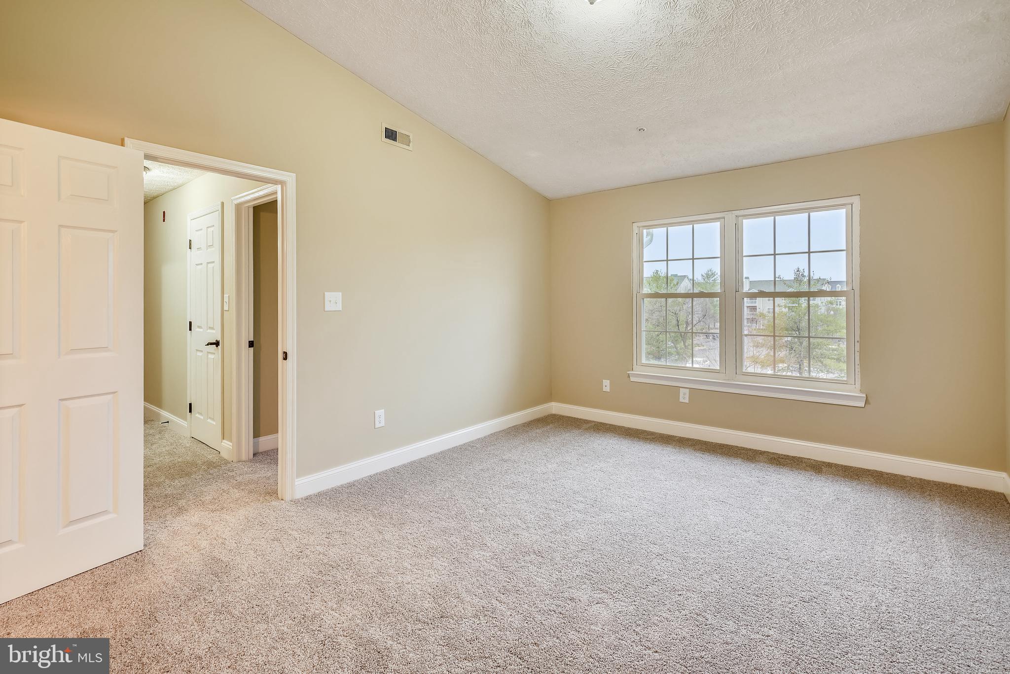 2408 Forest Edge Court, Unit 303 Odenton, MD 21113 - Photo 14 of 46 an empty room with windows and closet