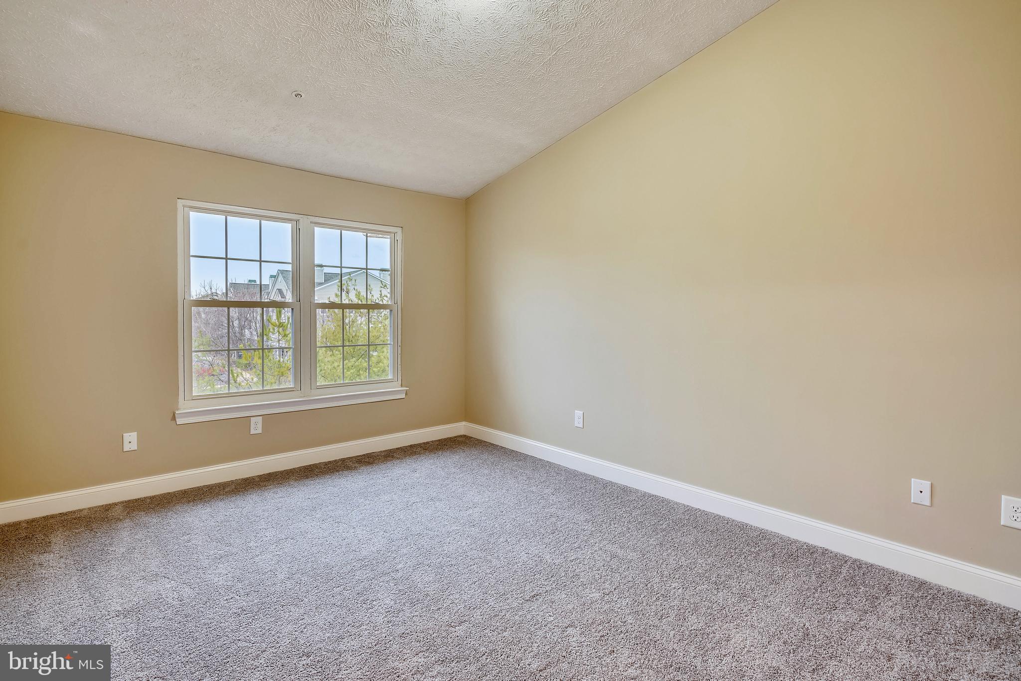 2408 Forest Edge Court, Unit 303 Odenton, MD 21113 - Photo 16 of 46 an empty room with windows