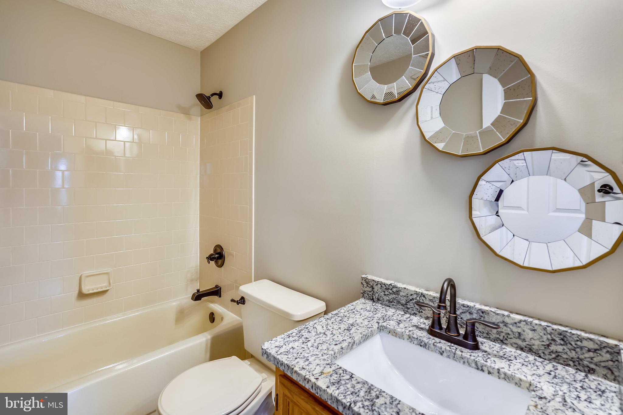 2408 Forest Edge Court, Unit 303 Odenton, MD 21113 - Photo 18 of 46 a bathroom with a sink and a mirror