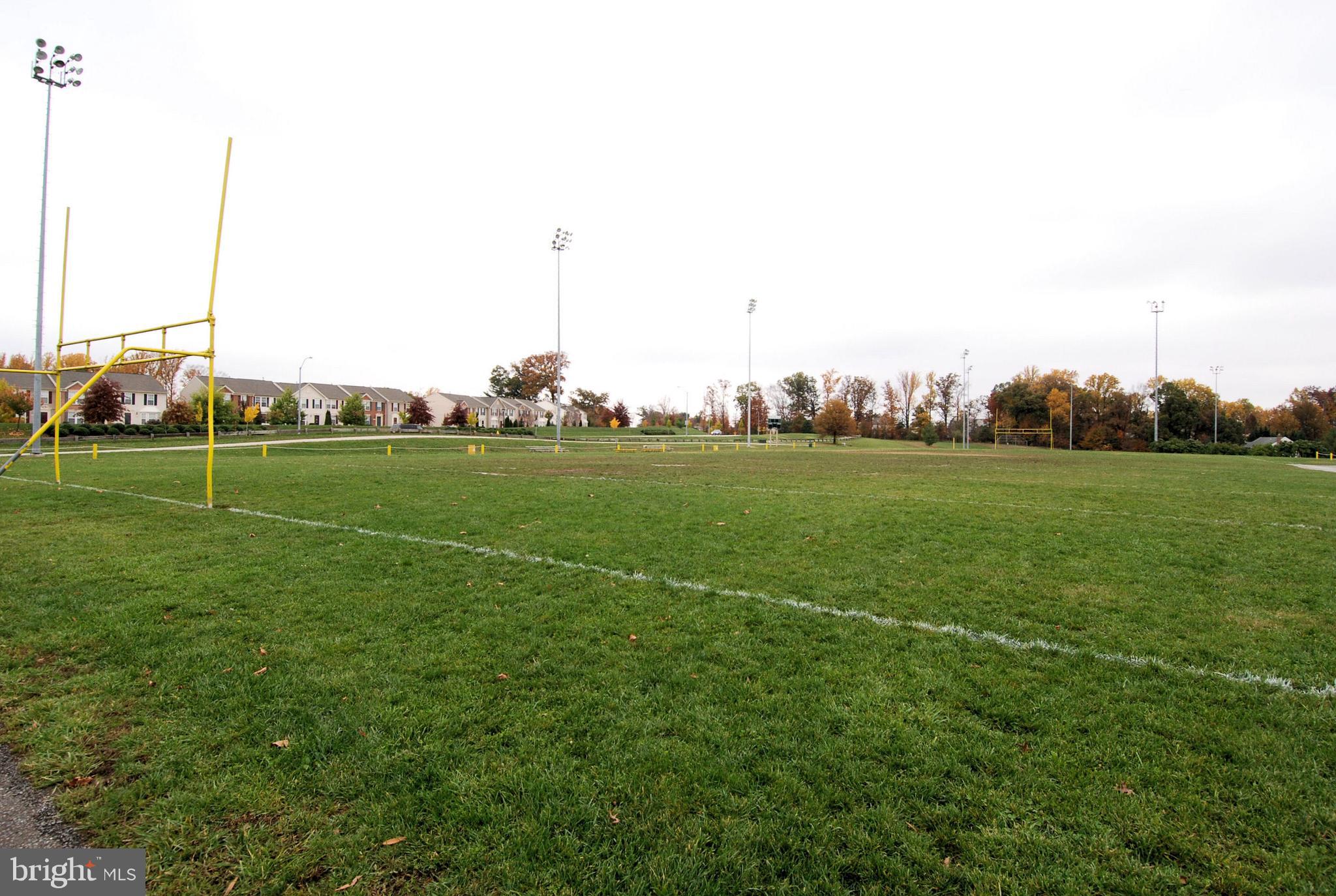 2408 Forest Edge Court, Unit 303 Odenton, MD 21113 - Photo 27 of 46 a view of a field with a big yard