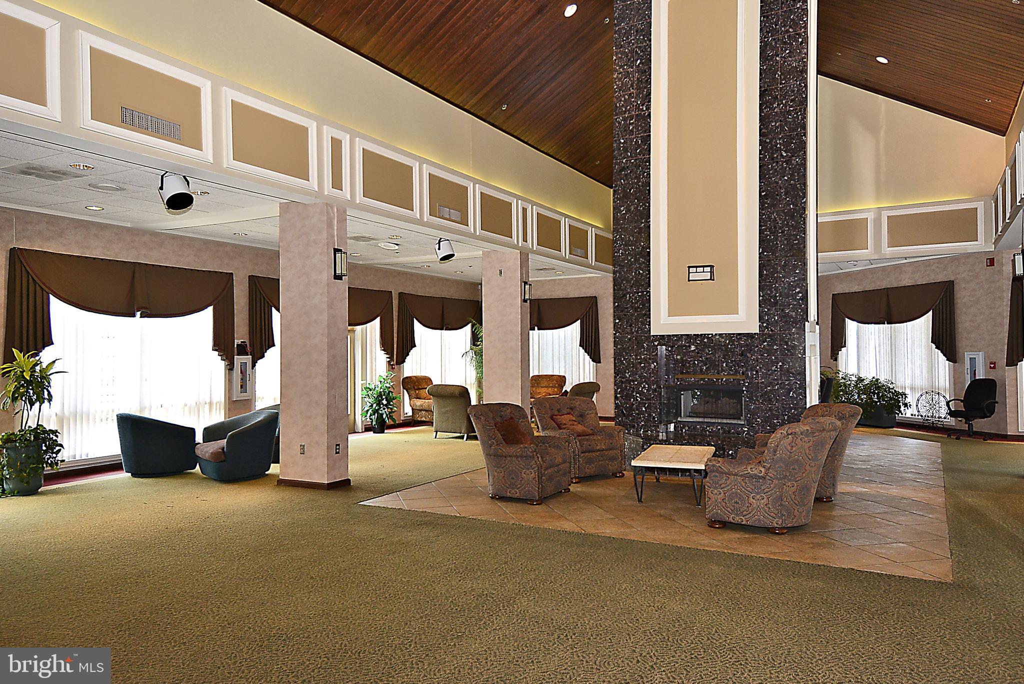 2408 Forest Edge Court, Unit 303 Odenton, MD 21113 - Photo 30 of 46 a building outdoor space with patio furniture and potted plants