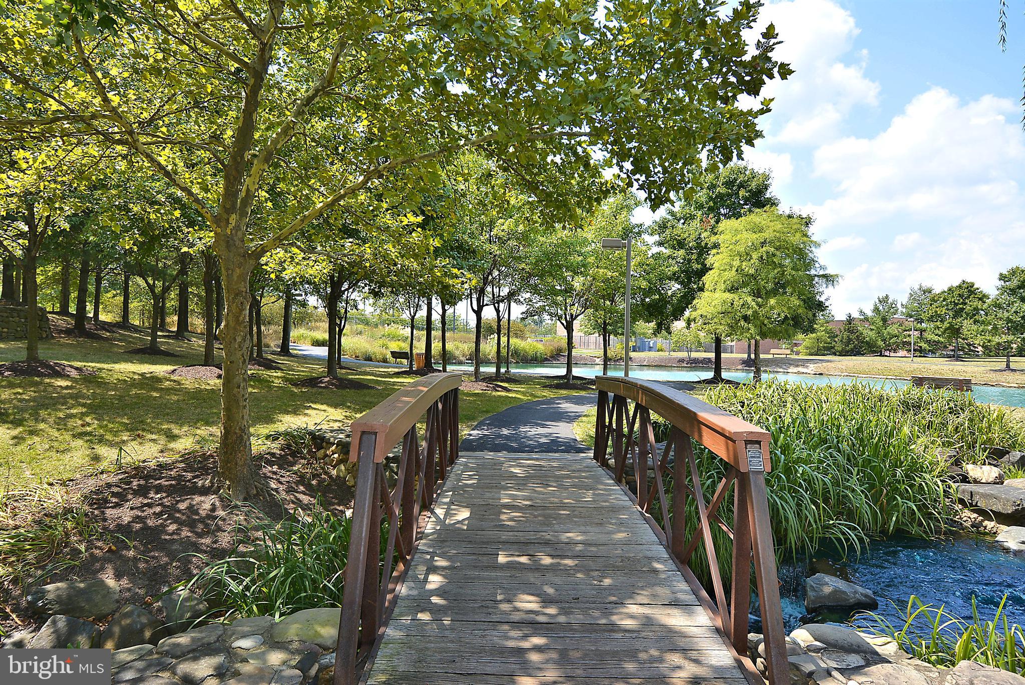 2408 Forest Edge Court, Unit 303 Odenton, MD 21113 - Photo 45 of 46 a view of a street with large trees