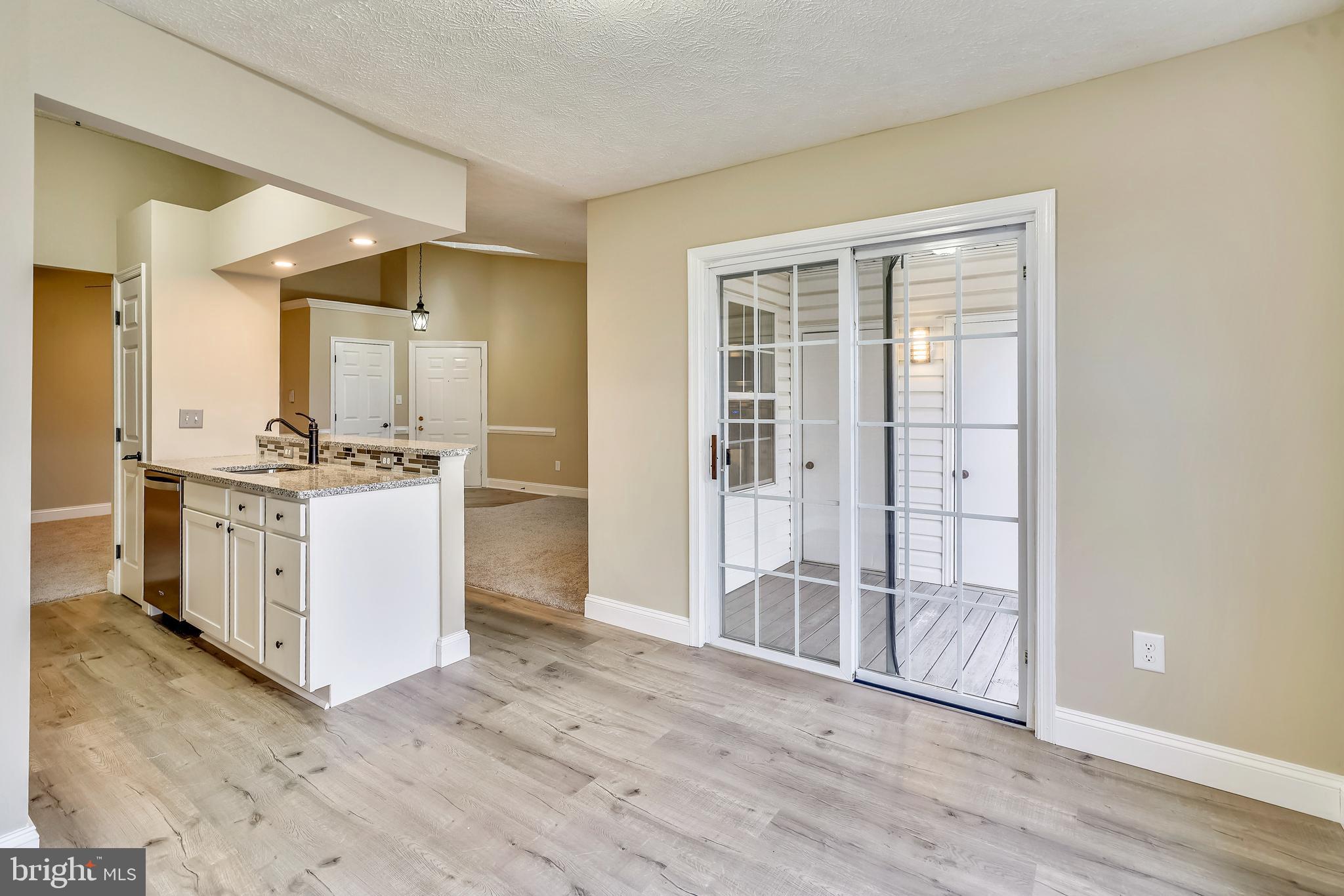 2408 Forest Edge Court, Unit 303 Odenton, MD 21113 - Photo 7 of 46 a view of kitchen with stainless steel appliances cabinets and wooden floor