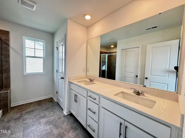 a bathroom with a glass shower door