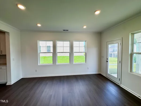 an empty room with wooden floor and a window