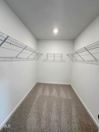 a spacious bathroom with a double vanity sink and mirror