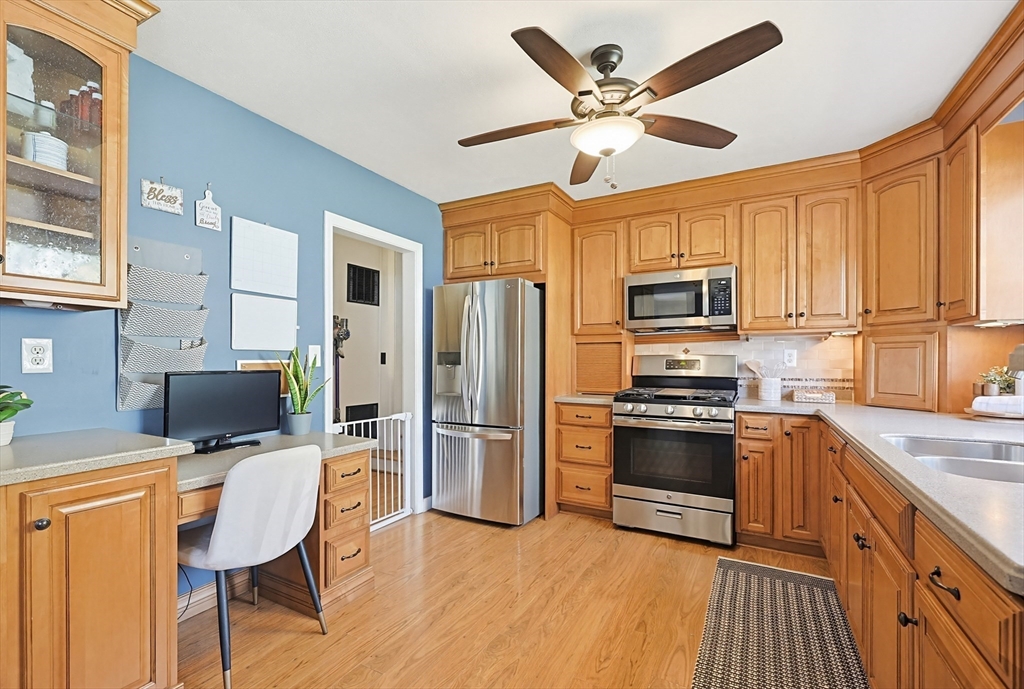 18 Anchorage Road Franklin, MA 02038 - Photo 9 of 42 a kitchen with stainless steel appliances granite countertop a stove top oven a refrigerator a sink dishwasher and a dining table with wooden floor