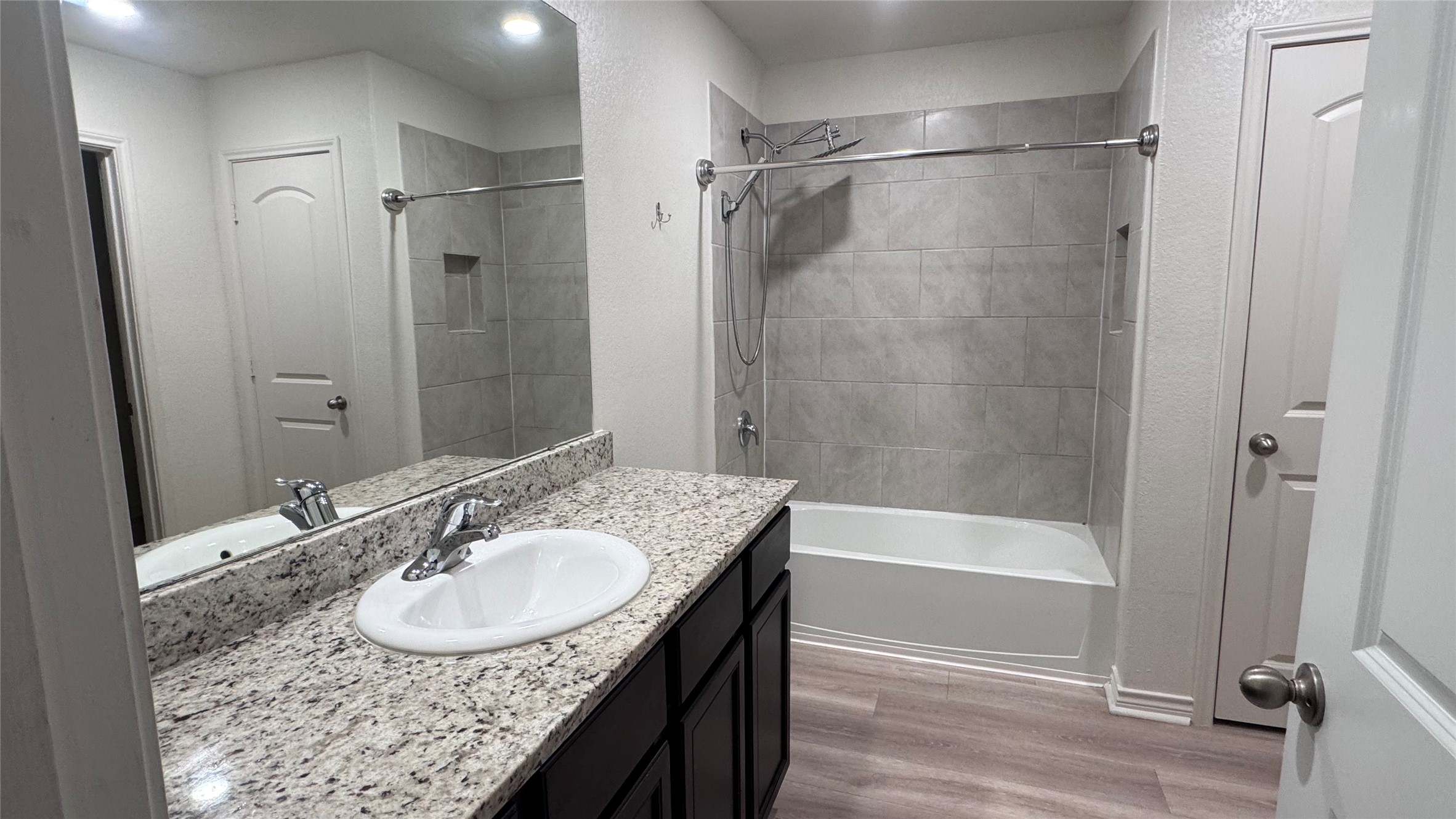 14421 Prairie Sod Lane Elgin, TX 78621 - Photo 10 of 10 Granite counters and tiled shower enclosure highlight this well-appointed bathroom.