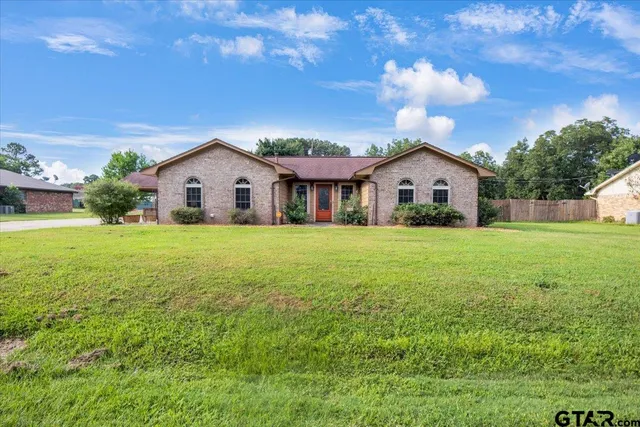 a view of house with yard and green space