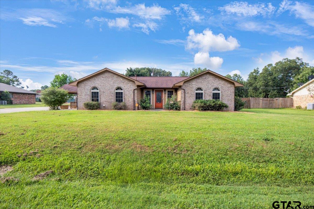 a view of house with yard and green space