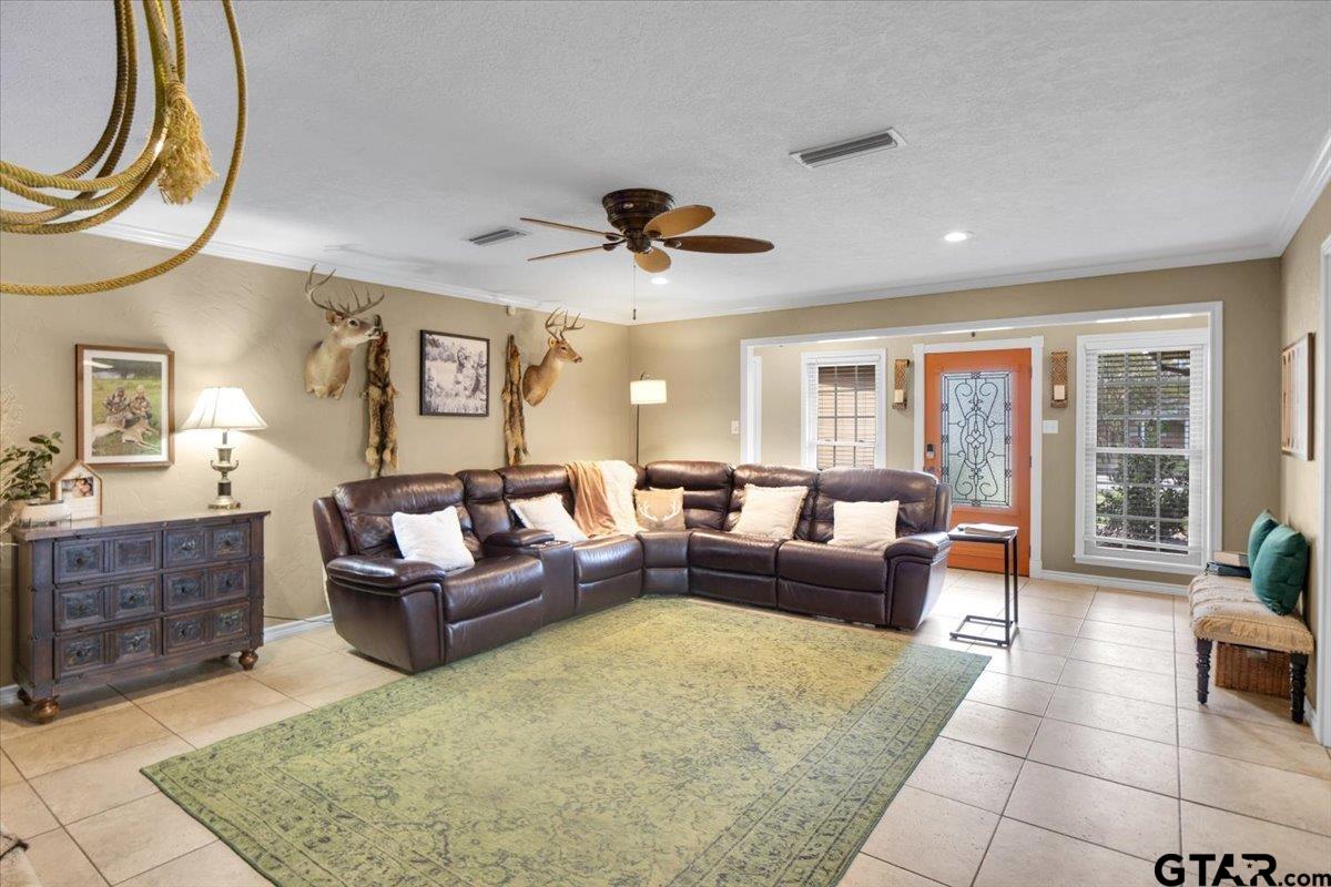 906 Zola Street Quitman, TX 75783 - Photo 16 of 41 a living room with furniture a chandelier and a rug