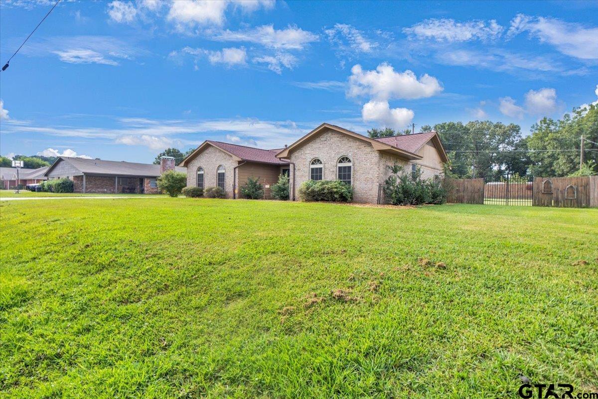 906 Zola Street Quitman, TX 75783 - Photo 2 of 41 a view of a house with a yard and a large tree