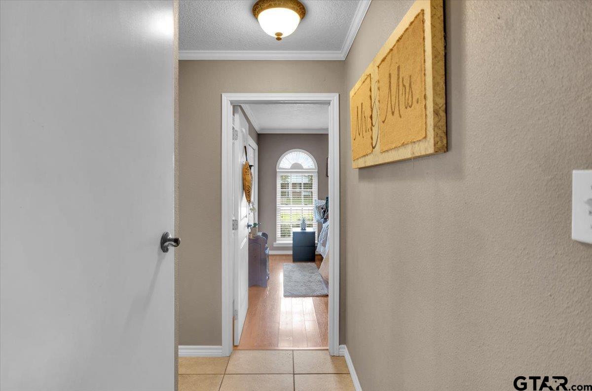 906 Zola Street Quitman, TX 75783 - Photo 22 of 41 a view of a hallway with wooden floor and a bathroom